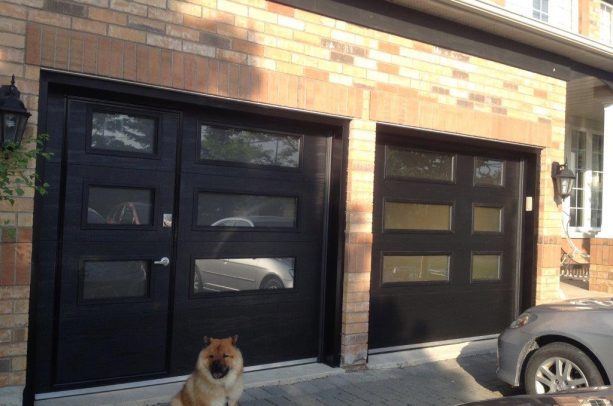 a man entry in one of the double modern black garage door