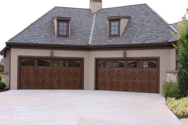 a shed exterior looks cozy with its brown color scheme and metal garage doors that looks like real wood