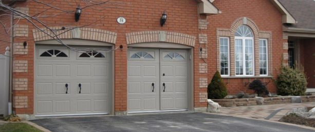 a walkthrough feature in a greige carriage-style garage door