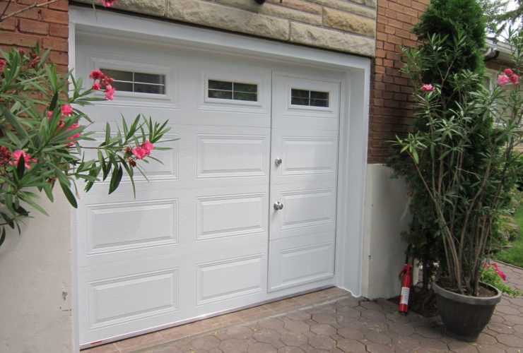 an elegant white garage door with integrated pedestrian entry and glass panels for natural light