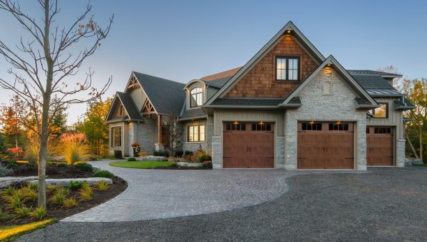 an exterior looks fabulous with the combination of grey and brown and the existence of a pair of elegant garage doors with wood look