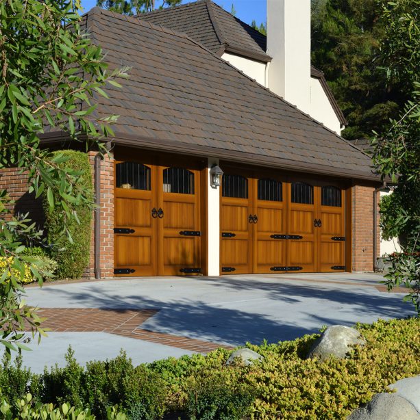 composite wood garage doors stained to make it look like the genuine ones