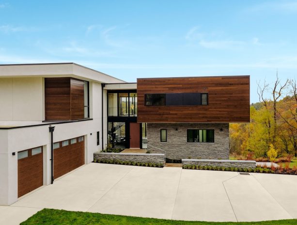 modern steel garage doors with ultra-grain walnut finish in a contemporary exterior design