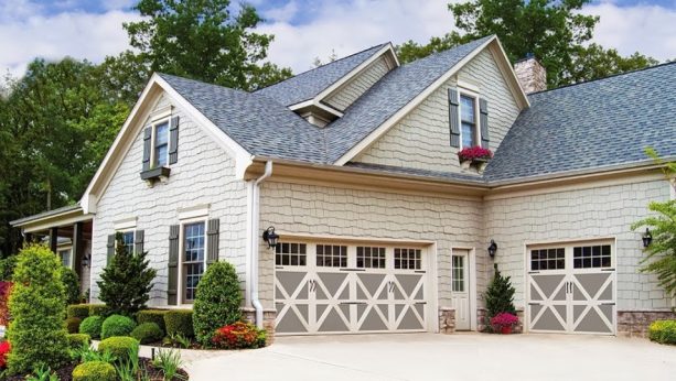 the charming look of grey and off-white faux wood garage doors in a stable-like craftsman exterior