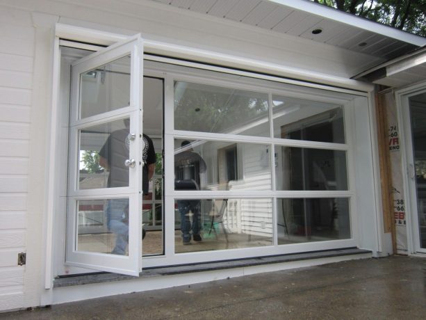 the exterior look of a glass sectional garage door with a pedestrian entrance on the left side
