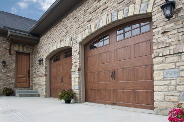 the faux wood steel garage doors matches the natural-looking brick exterior