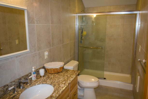 a traditional full bath in white and beige color theme