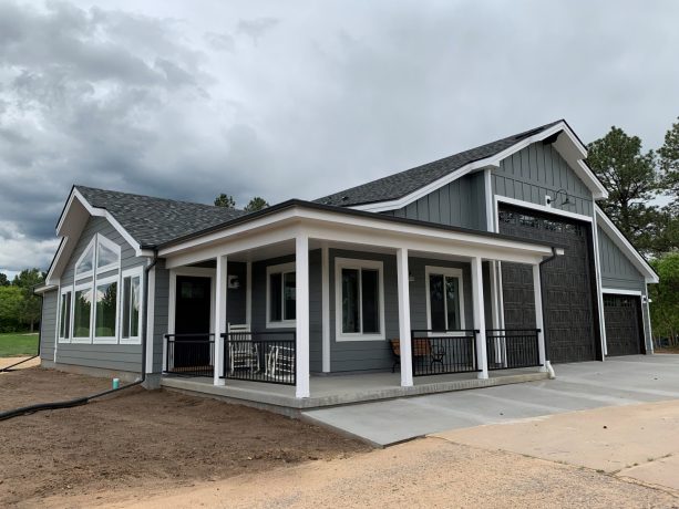 gorgeous RV garage in white and grey color located in the same level with an apartment and a workshop