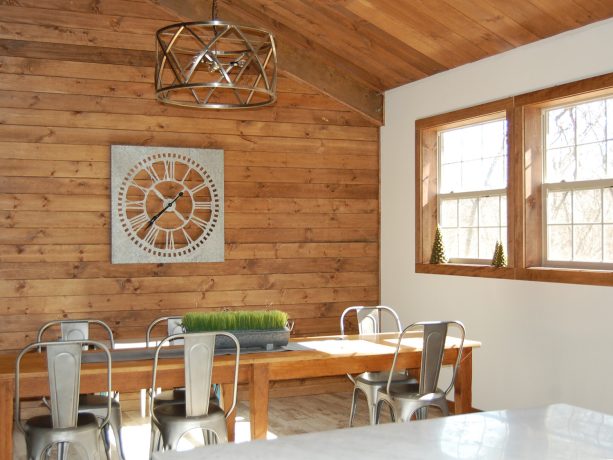 the dining area with long table and enough chairs for everyone