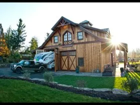 the front look of the timber RV garage and workspace with living quarters on the second floor