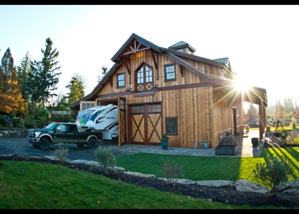 the front look of the timber RV garage and workspace with living quarters on the second floor