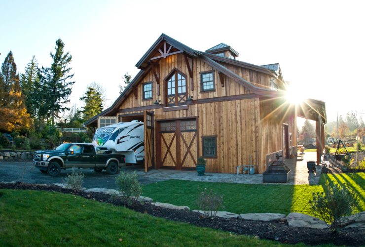 the front look of the timber RV garage and workspace with living quarters on the second floor