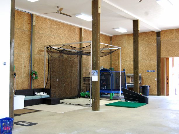 the golfing equipment stored in the storage area in the garage