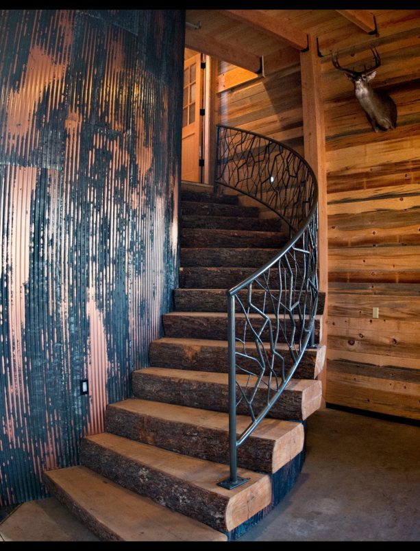 the rustic curved staircase in the RV garage interior