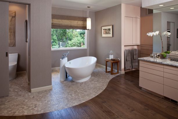 a cozy contemporary bathroom with the wood and mosaic stone tile as the floor