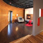 a hall and a living room with two different wood floor types