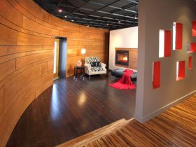 a hall and a living room with two different wood floor types