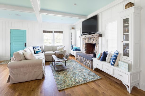a living room with matte-finished, medium tone, oak wood floor in a beach-style summer house