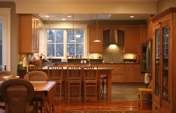 glossy hardwood floor and classic grey tile combination in an open kitchen and dining interior