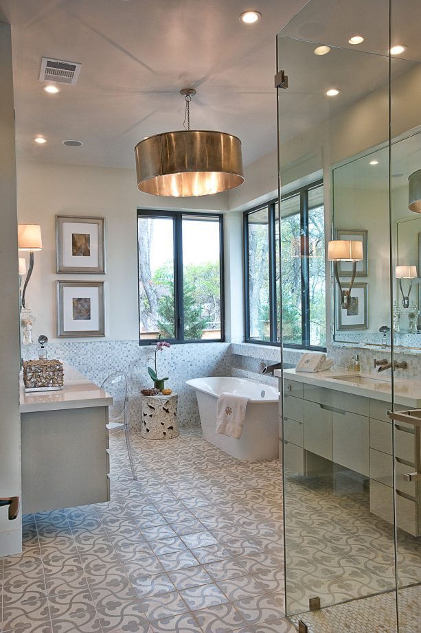 the bathroom looks nice with the white and grey decorative tile floor