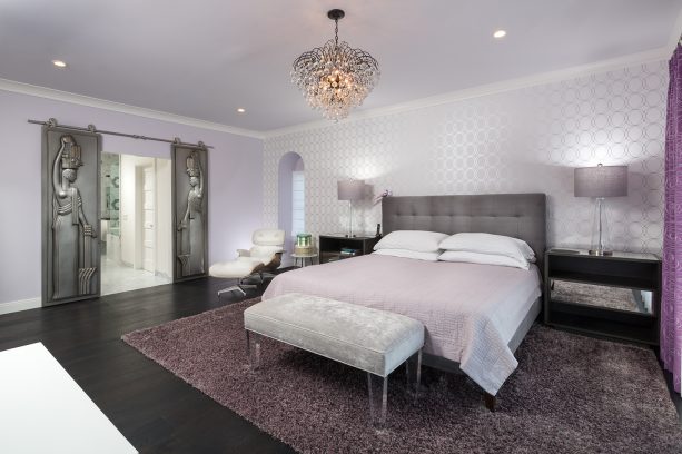 the bedroom looks gorgeous with the combination of dark wood floor, grey, and purple colors