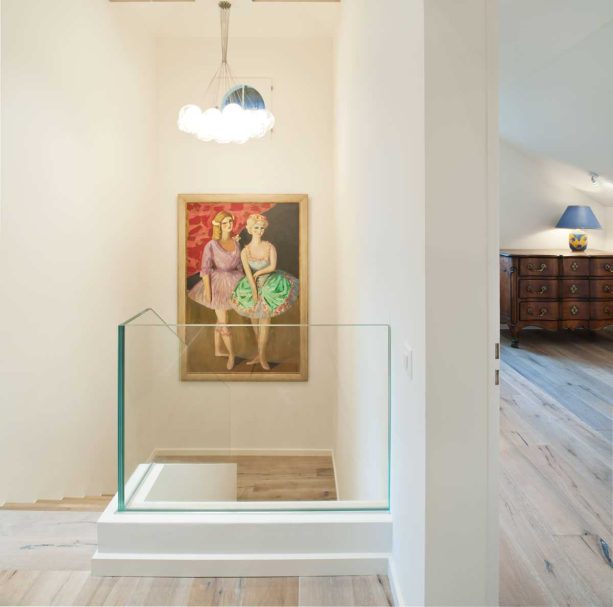 the light-tone wood flooring in the second floor of the transitional interior