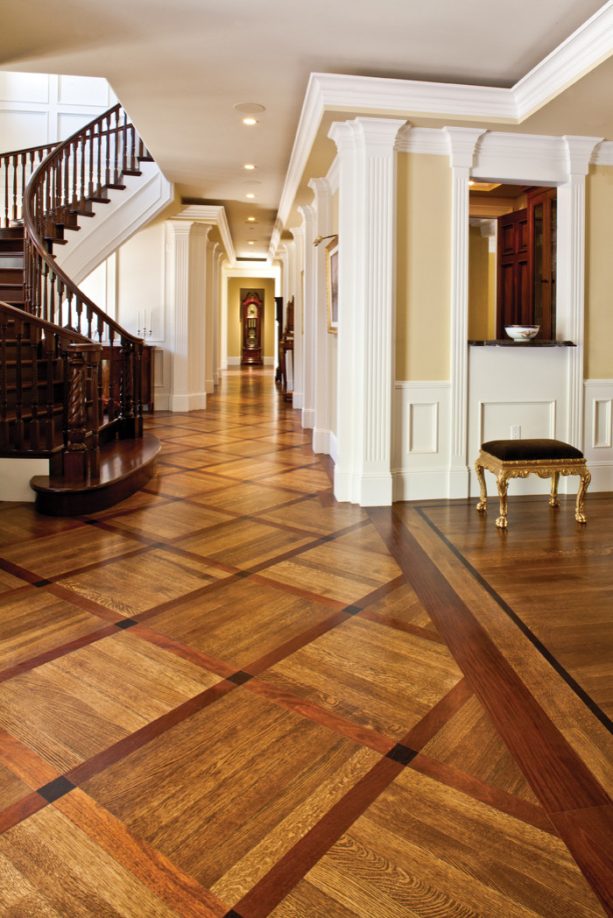 the pairing between common strip pattern and versailles parquet in the wood floor design of a Mediterranean interior