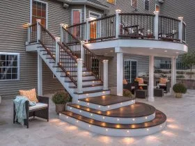 a custom outdoor stair railing with discreet post cap lighting for ambiance
