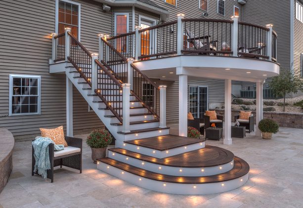 a custom outdoor stair railing with discreet post cap lighting for ambiance