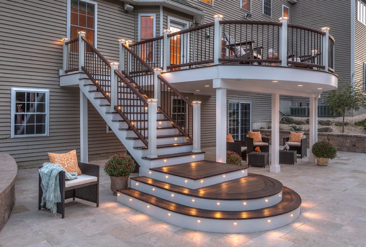 a custom outdoor stair railing with discreet post cap lighting for ambiance