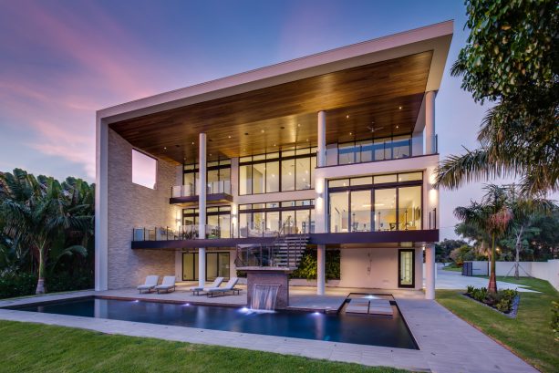 the glass stair railing matches the dominant glass window on the back part of the residence