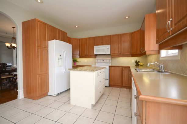 before reface - medium tone wood cabinets in a contemporary kitchen