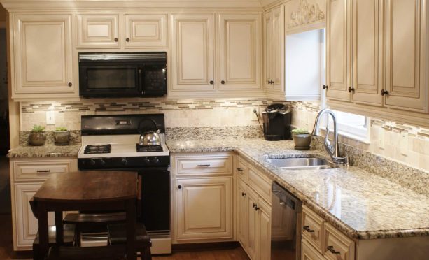 after reface - the cabinets get a new white color and doors but the backsplash and countertops are still the same