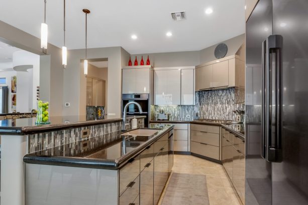 the high-gloss, sleek grey cabinets after getting refaced