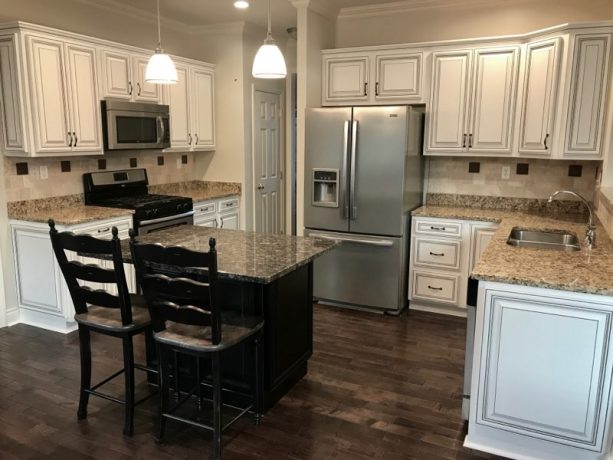 the new white color of the kitchen cabinets, complete with black glazing