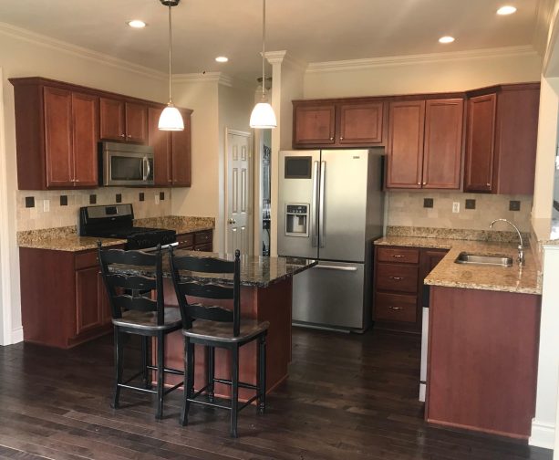 before reface - the old kitchen cabinets has an ordinary look with brown color to match the interior scheme