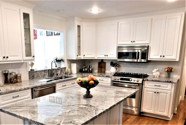 the refaced cabinets creates a crisp ambiance and clean look in the kitchen area