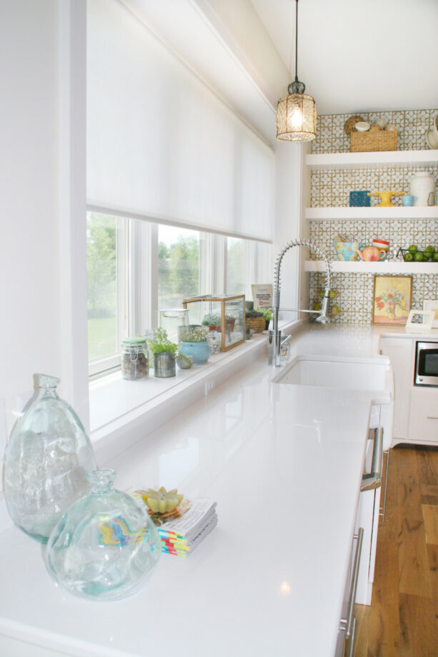 a white garden window with various types of small potted plants