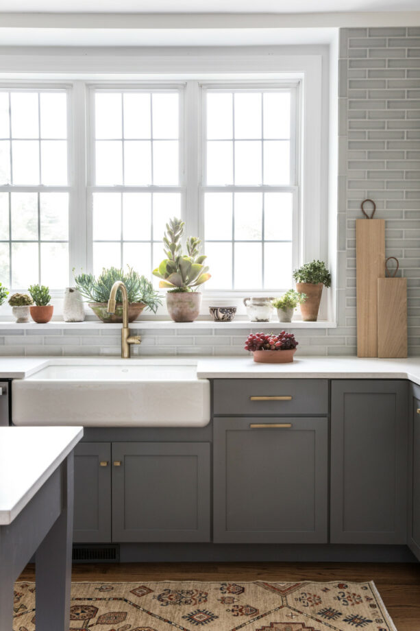 an indoor succulent garden in a custom window over the sink