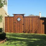 craftsman style board on board fence with wooden gate