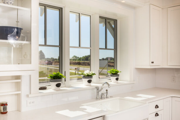 large garden windows in a minimalist farmhouse kitchen for ample sunlight access