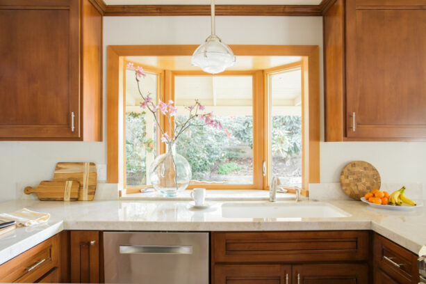 medium tone wood garden window over an undermount kitchen sink