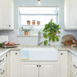 the garden window over sink allow more natural light to brighten the small U-shaped kitchen