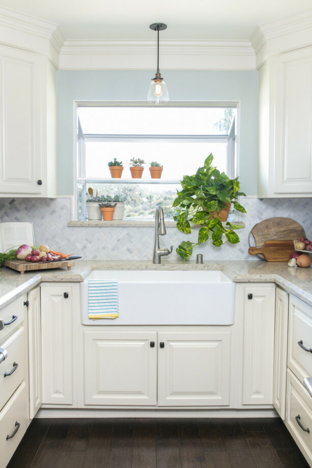 the garden window over sink allow more natural light to brighten the small U-shaped kitchen