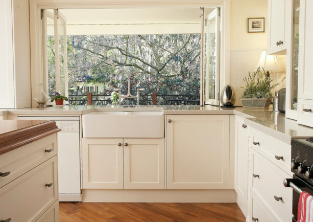a kitchen garden window with double folded opening over an undermount traditional farmhouse sink