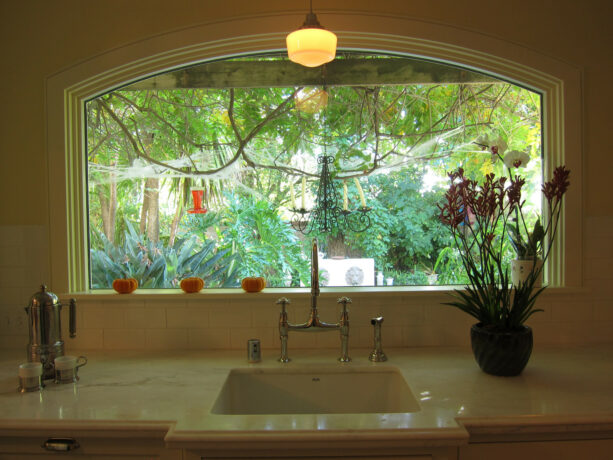 panoramic garden window over a white sink showing a beautiful green view outside