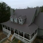 an exterior design with burnished slate metal roofing to cover its old shingles
