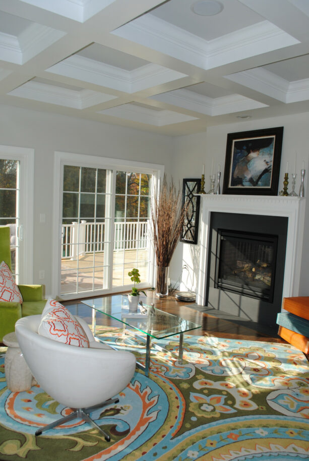 a contemporary living room with black, gray, and white walls color theme and colorful decorations