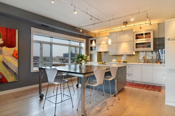 a contemporary open kitchen and dining room with accentuating Whale Gray wall and Gray Owl ceiling