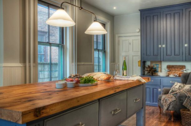 a traditional kitchen with Gray Owl walls and Evening Sky cabinets and island